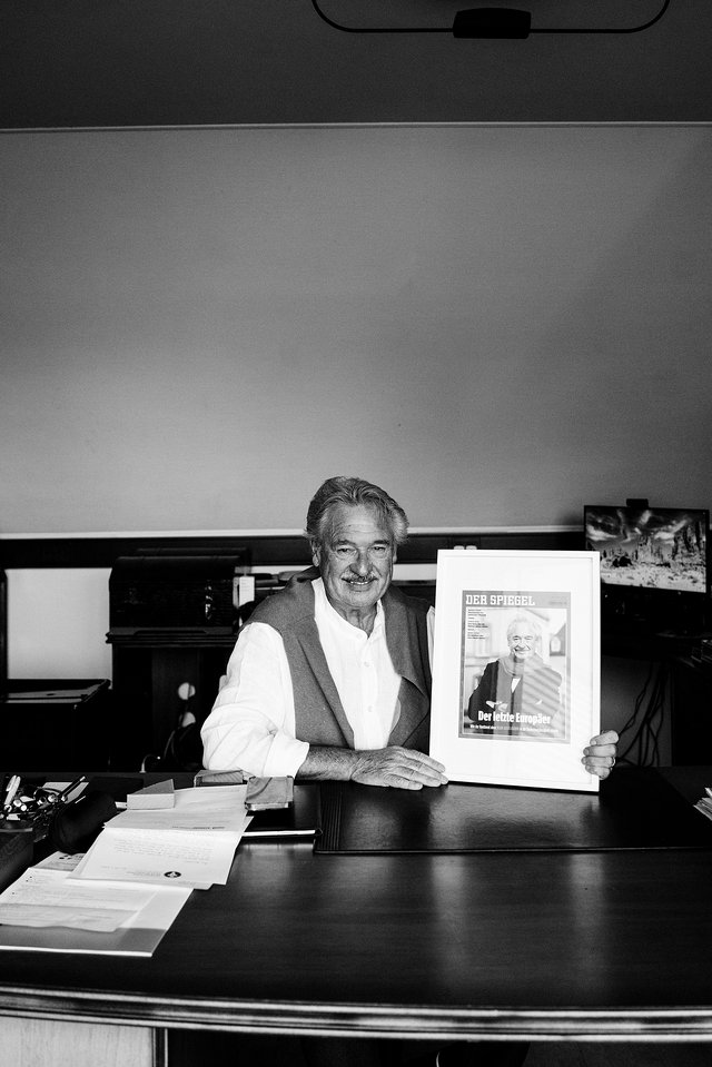 Jean Asselborn exhibant une fausse Une du Spiegel que lui ont offert des  journalistes du magazine allemand
